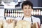 Confident Salesman Arranging Cheese In Shop