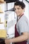 Confident Salesman Packing Cheese At Grocery Store