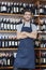 Confident Salesman Standing Arms Crossed In Wine Shop