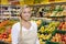 Confident Saleswoman Smiling By Fruit Crates In Supermarket