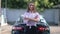 Confident satisfied female client standing at clean vehicle at car wash service crossing hands looking at camera