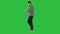 Confident serious man walking and working in tablet on a Green Screen, Chroma Key.