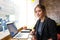 Confident serious woman skilled business worker looking in camera while sitting in coffee shop