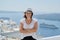Confident smiling woman tourist traveling on luxury cruise in Mediterranean, Greece, Santorini