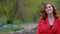 Confident smiling woman walking red curly hair