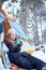 Confident solo woman traveller camping through an evergreen winter forest in Canada