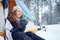 Confident solo woman traveller camping through an evergreen winter forest in Canada