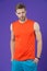 Confident sportsman. Man handsome sports clothing violet background. Athlete sportsman confident puts hands into pockets