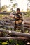 Confident strong lumberjack work on sawmill and sawing big tree with ax.