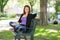 Confident Student Sitting On Bench At Campus