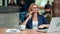 Confident stylish business female talking using smartphone sitting on table in cafe