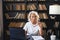 Confident stylish middle aged senior woman using laptop at workplace. Older mature lady businesswoman sitting at office