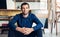 Confident and successful businessman sitting in a large work studio