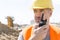 Confident supervisor using walkie-talkie at construction site