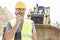 Confident supervisor using walkie-talkie at construction site