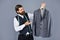 Confident tailor designing male jacket. handsome sartor with tape measure. male beauty and fashion. bearded man