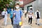 Confident teen boy in medical mask going to lessons on autumn day
