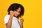 Confident teen curly girl in white t-shirt shows fists, ready to fight with bullying