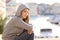 Confident teenager girl looking at camera in a coast town