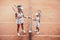 confident tennis coach and little girl standing against against each other before the game