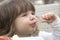 Confident toddler eating with spoon