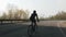 Confident triathlete riding bicycle. Triathlon training. Follow shot of cyclist pedaling on bicycle.