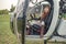 Confident tween girl in mirrored sunglasses sitting in helicopter