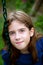 Confident Tween Sitting On a Swing