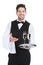 Confident Waiter Carrying Champagne Flutes On Tray