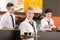 Confident waitress serving coffee with tray