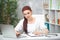 Confident woman doctor sitting at the table in her office and works at the computer. healthcare concept