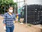 Confident woman in mask posing near greenhouse