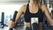 Confident woman training on a exercise machine at the gym