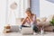 Confident woman using computer in her apartment