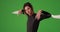 Confident woman in wetsuit holding kayak paddle over shoulders on greenscreen