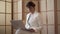 Confident woman in a white suit working with a laptop sitting at home or in the modern office. Businesswoman finishing