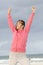 Confident woman in winning pose at beach