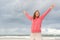 Confident woman in winning pose at ocean