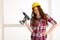 Confident woman works with batery drill machine DIY