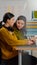 Confident women photo editors sitting at workplace in creative studio