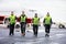 Confident Workers Walking On Runway During Rainy Season