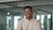 Confident young African American business man standing in office, portrait.