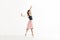 Confident Young Ballerina Dancing Gracefully On White Background