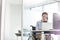 Confident young disabled businesswoman working at desk in office