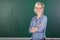 Confident Young Female Teacher In Front Of Chalkboard