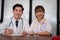 Confident young male & female doctor smiling at camera. Portrai
