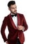 Confident young model in red velvet tuxedo looking to side