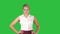 Confident young pretty waitress walking with hands on hip on a Green Screen, Chroma Key.