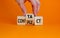 Conflict or contact symbol. Businessman turns the wooden cube and changes the word `conflict` to `contact`. Beautiful orange