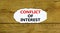 Conflict of interest symbol. Words `Conflict of interest` on white paper. Beautiful wooden background. Business, conflict of